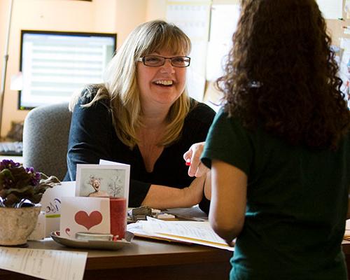 A JU advisor meeting with a student whose back is to the camera.