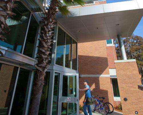 A student walking into Davis College of Business & Technology